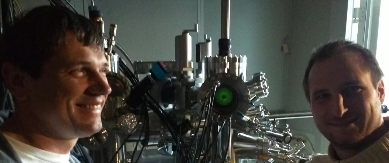 Two researchers beside an ultra-high-vacuum scanning probe instrument in the laboratory